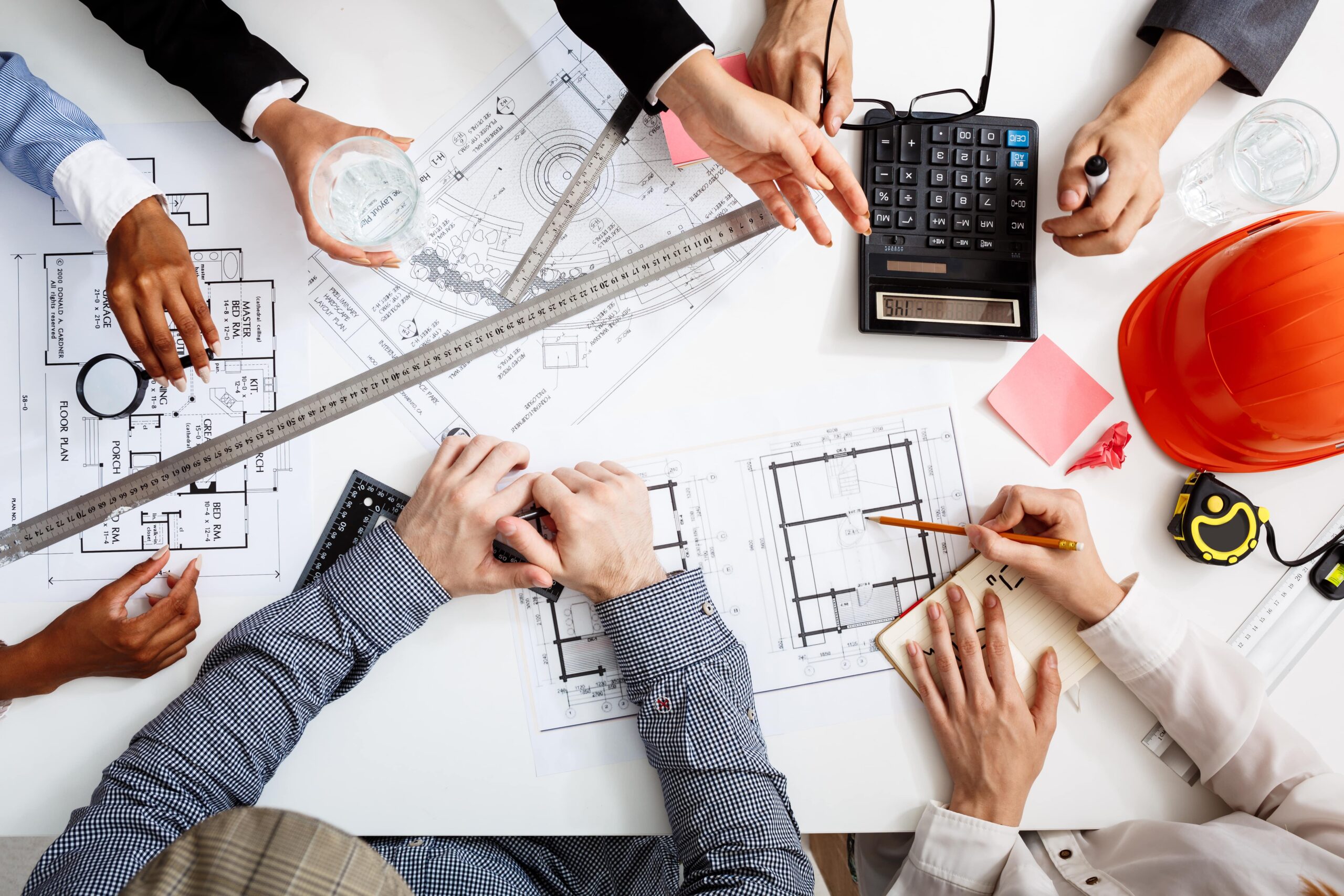 businessmen-hands-white-table-with-documents-drafts-min